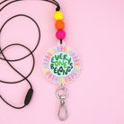 Acrylic and silicone teacher lanyard for Harmony Day with the words 'Everyone Belongs' written in a world with rainbow people around it